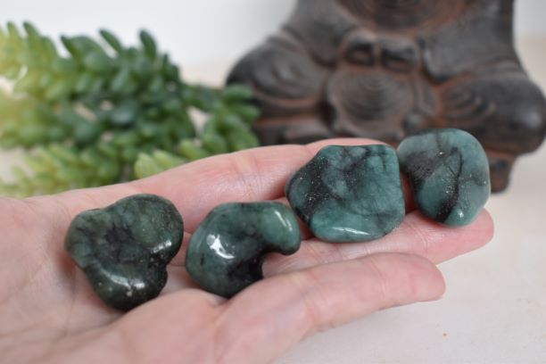 emerald tumbled gemstone in hand to show size.Use for crystal grids and metaphysical healing.
